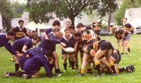 A group of people are playing rugby on a field.