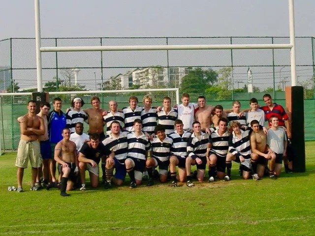 A group of men posing for a picture on a field