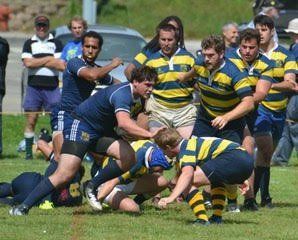 A group of men are playing rugby on a field.