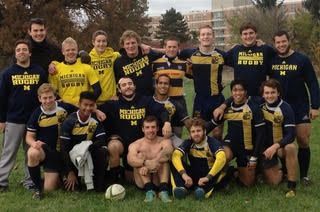 A group of men wearing michigan rugby shirts pose for a picture