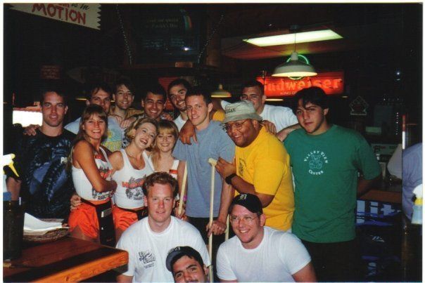 A group of people posing in front of a sign that says motion