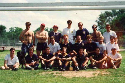 A group of men are posing for a picture in a field