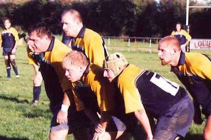 A group of rugby players are lined up on a field.