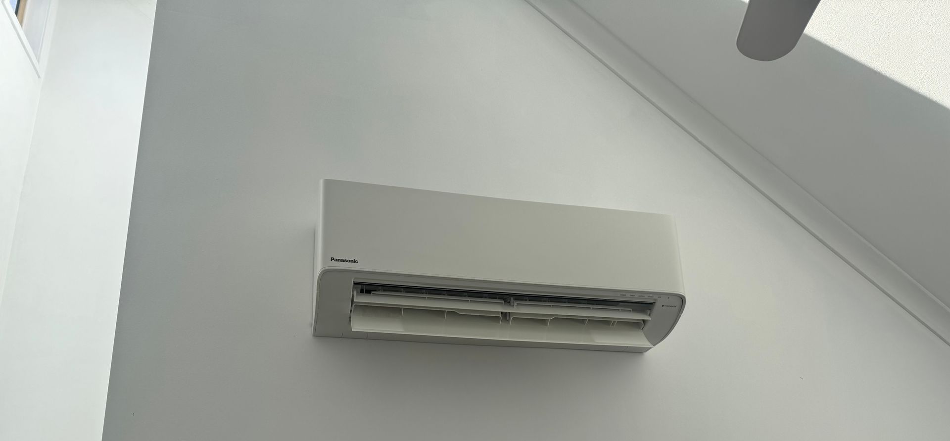 Wall-mounted Panasonic air conditioner unit in a home, serviced as part of air conditioner service in Nowra