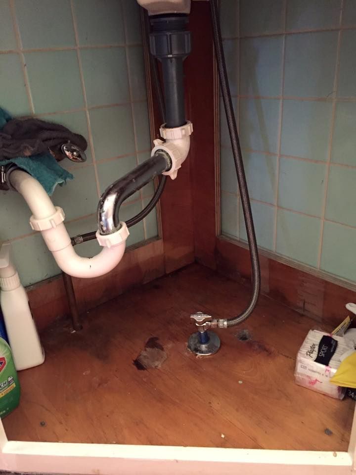 A bathroom sink with a hose attached to it.