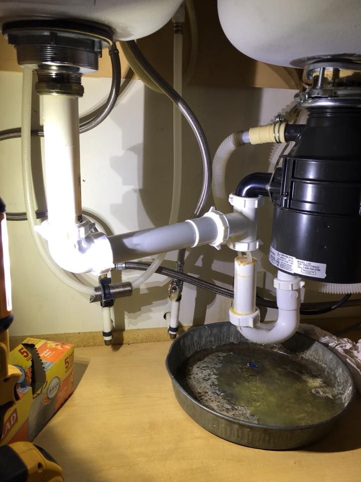 A sink with a garbage disposal underneath it