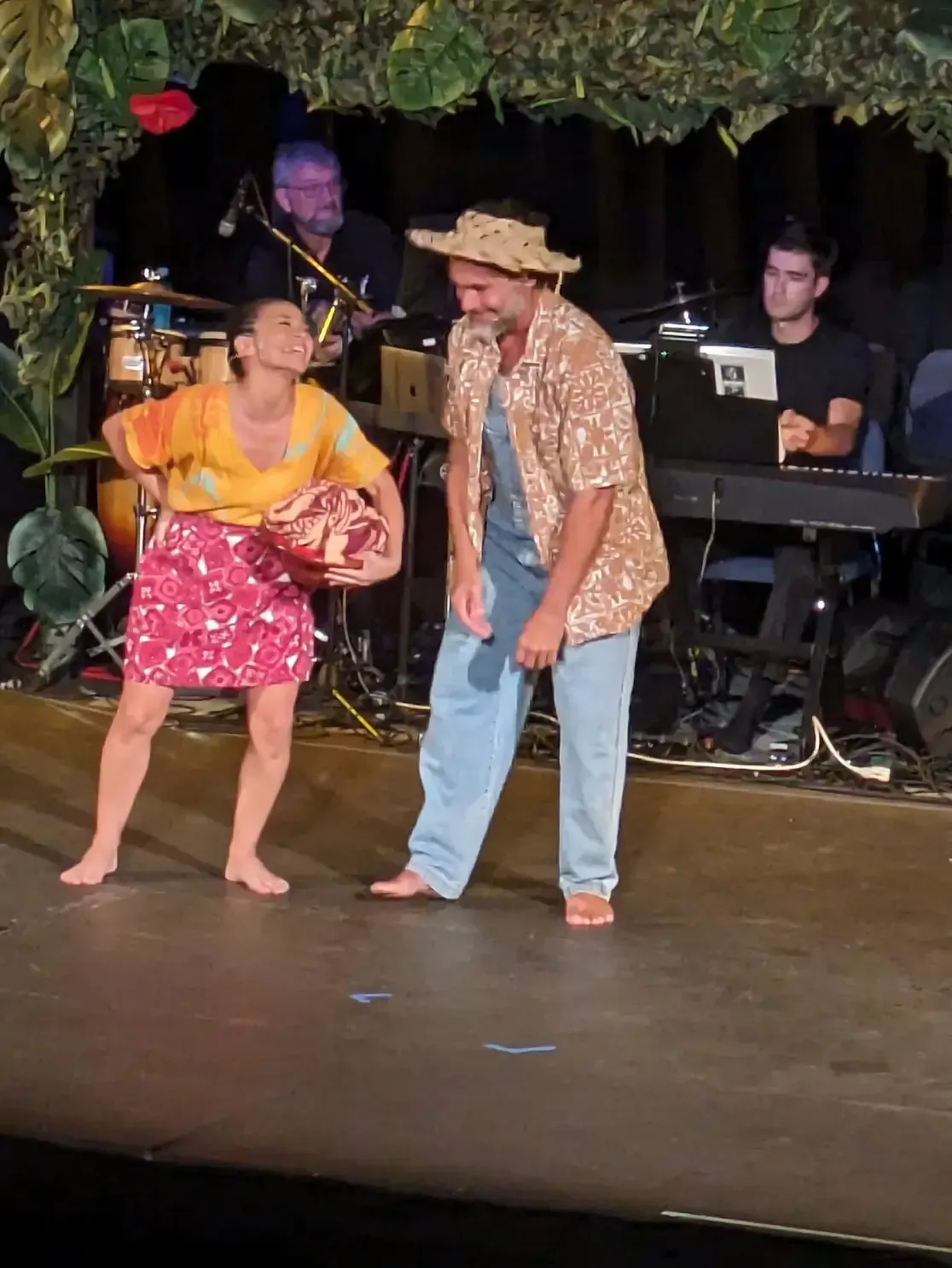 A man and a woman are dancing on a stage.