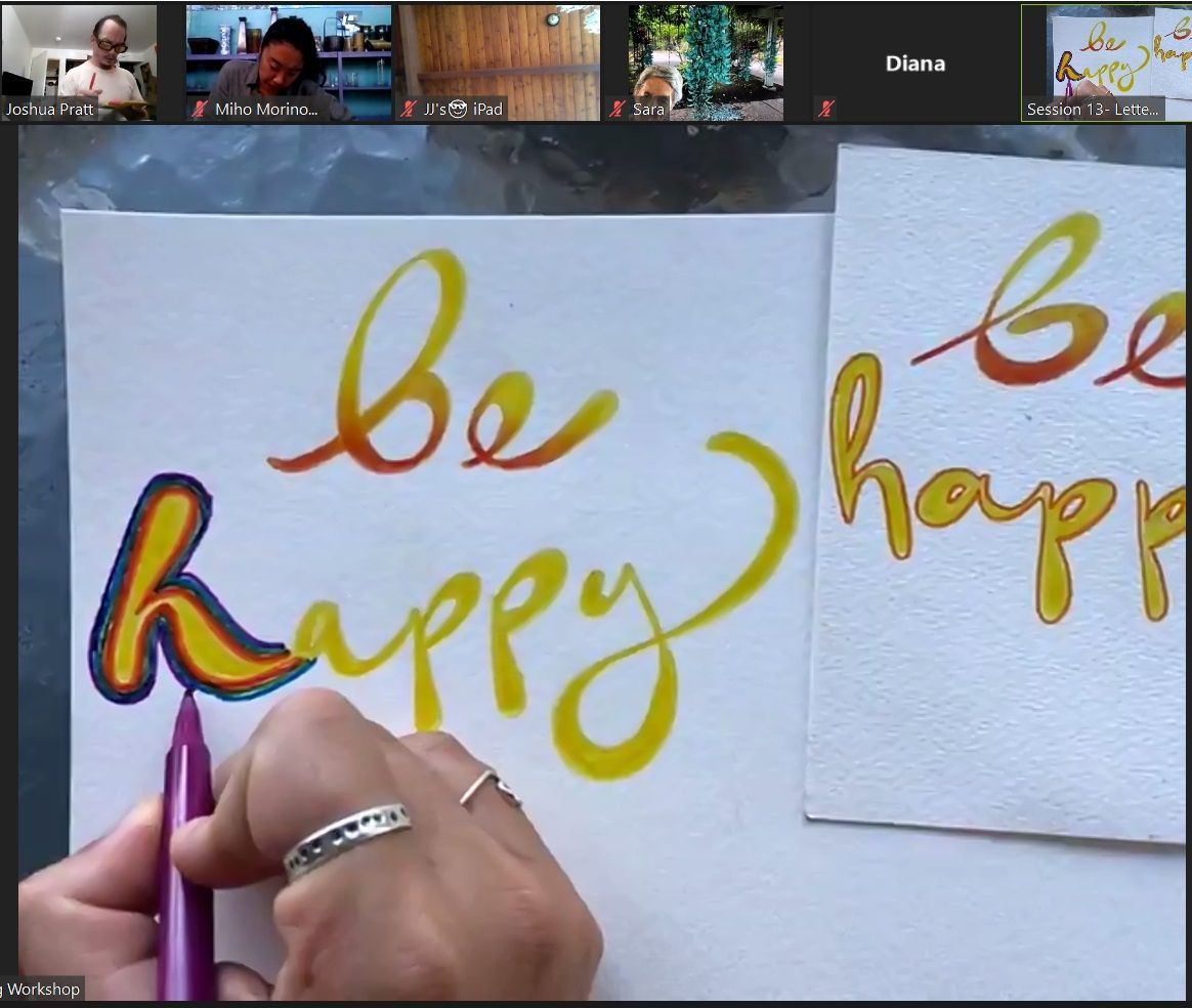 A person is writing on a piece of paper that says be happy