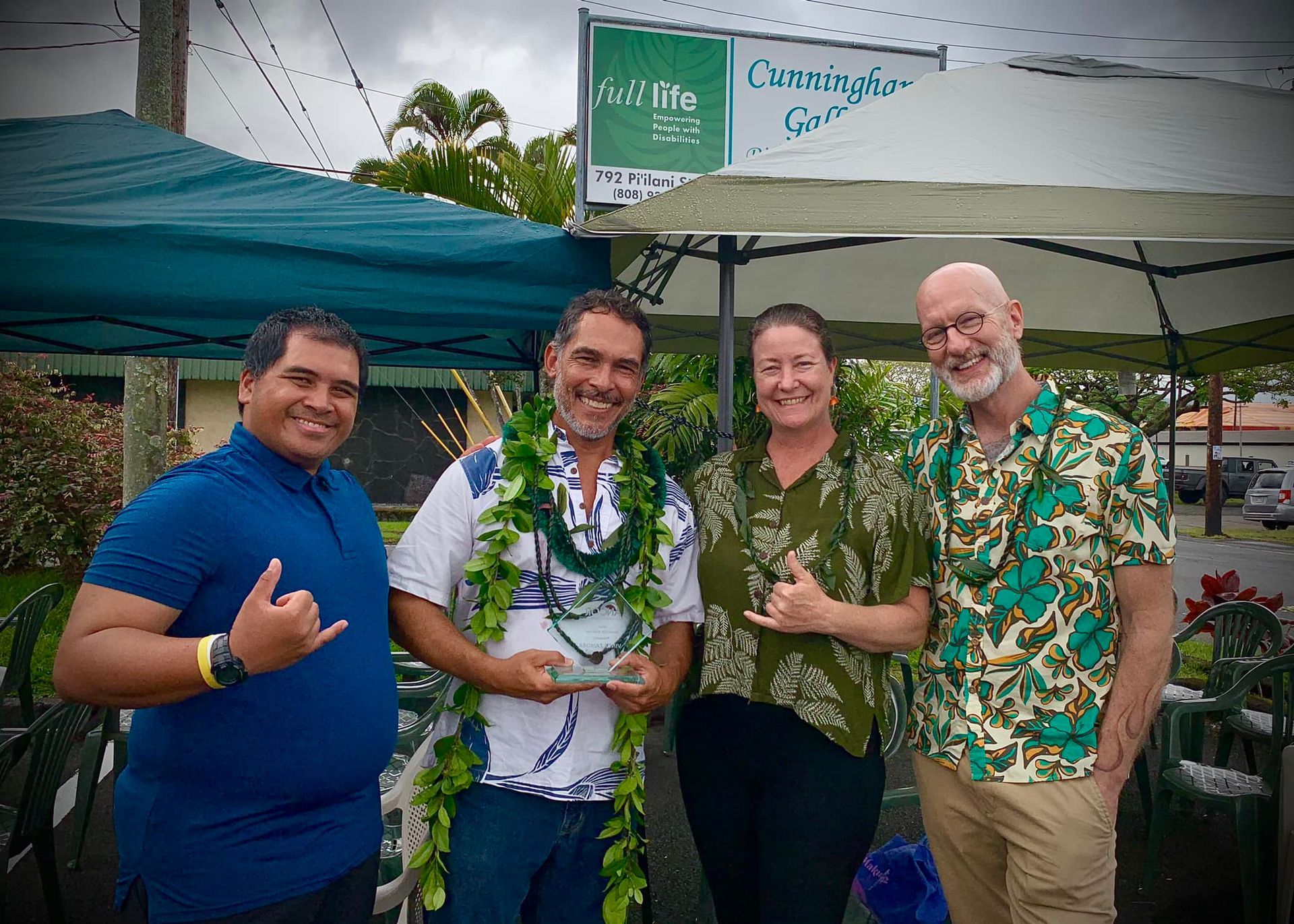 A group of people are posing for a picture in front of a tent.