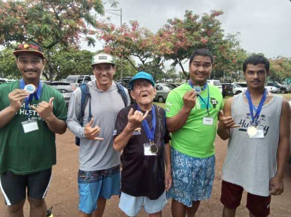 A group of young men posing for a picture with medals around their necks