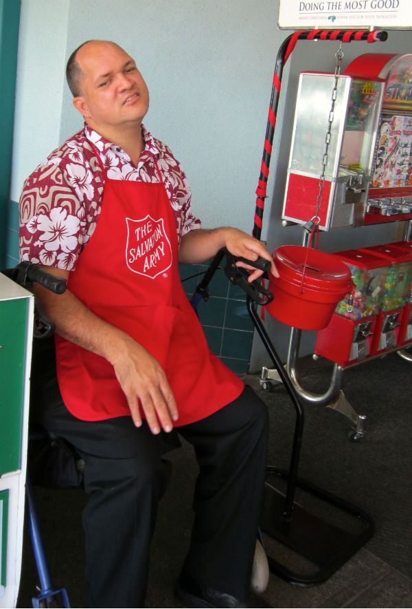 A man wearing a red apron that says the salvation army