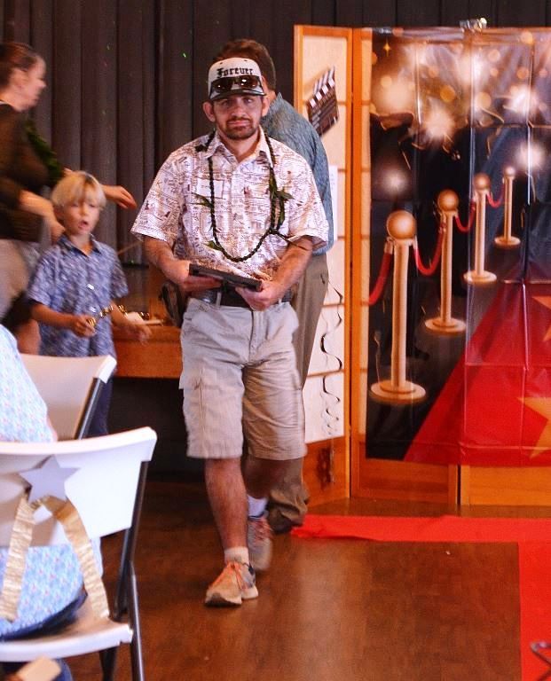 A man wearing a headband that says texas is walking down a red carpet