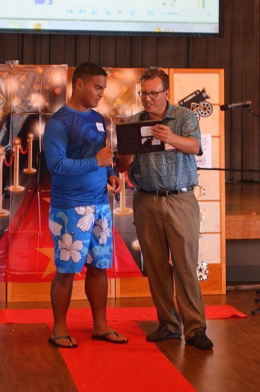 Two men standing next to each other on a red carpet