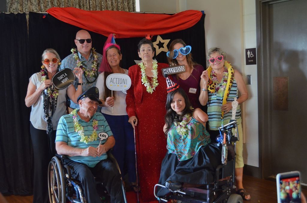 A group of people in wheelchairs are posing for a picture.