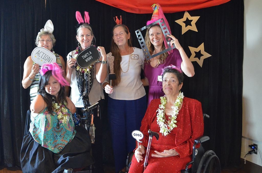 A group of women posing for a picture with one woman in a wheelchair