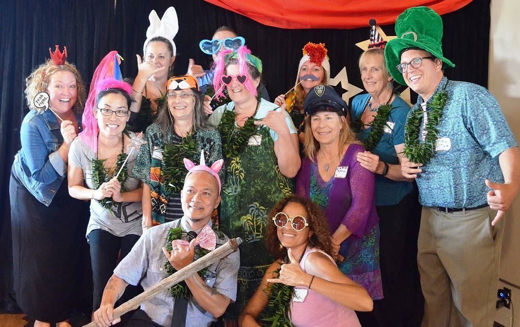 A group of people are posing for a picture in a photo booth.