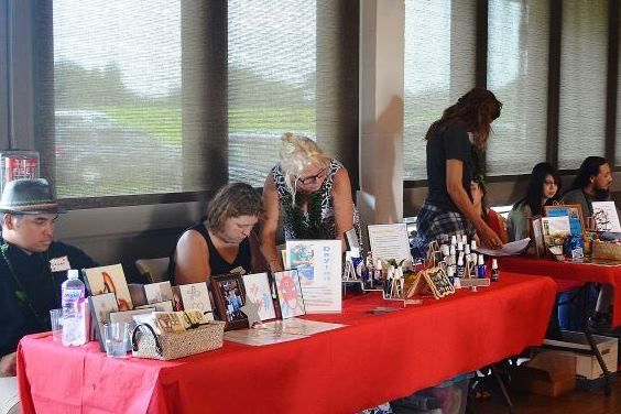 A group of people are sitting at tables in a room.