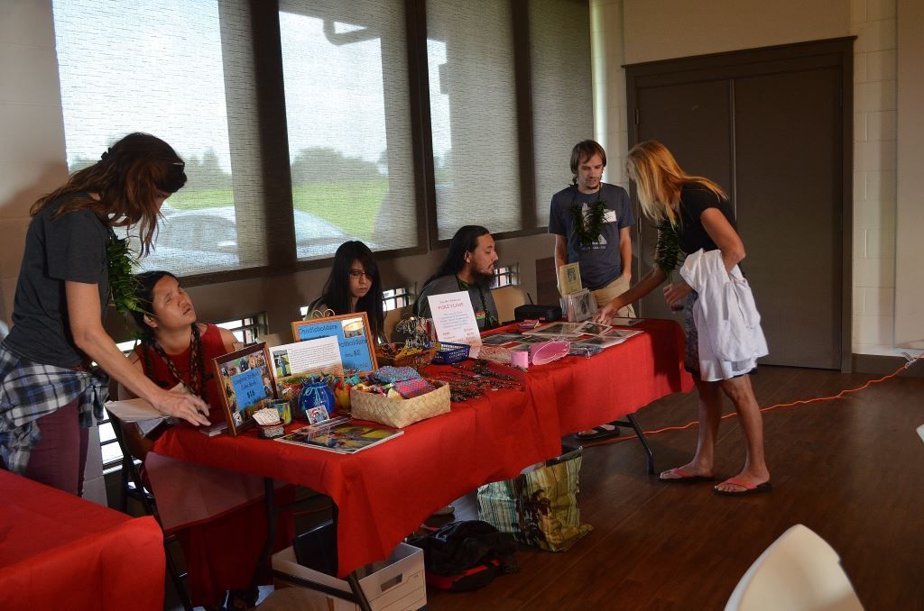 A group of people are standing around a table in a room.