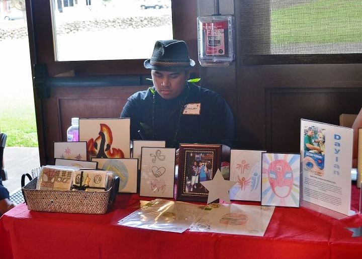 A man in a hat is sitting at a table with cards on it.
