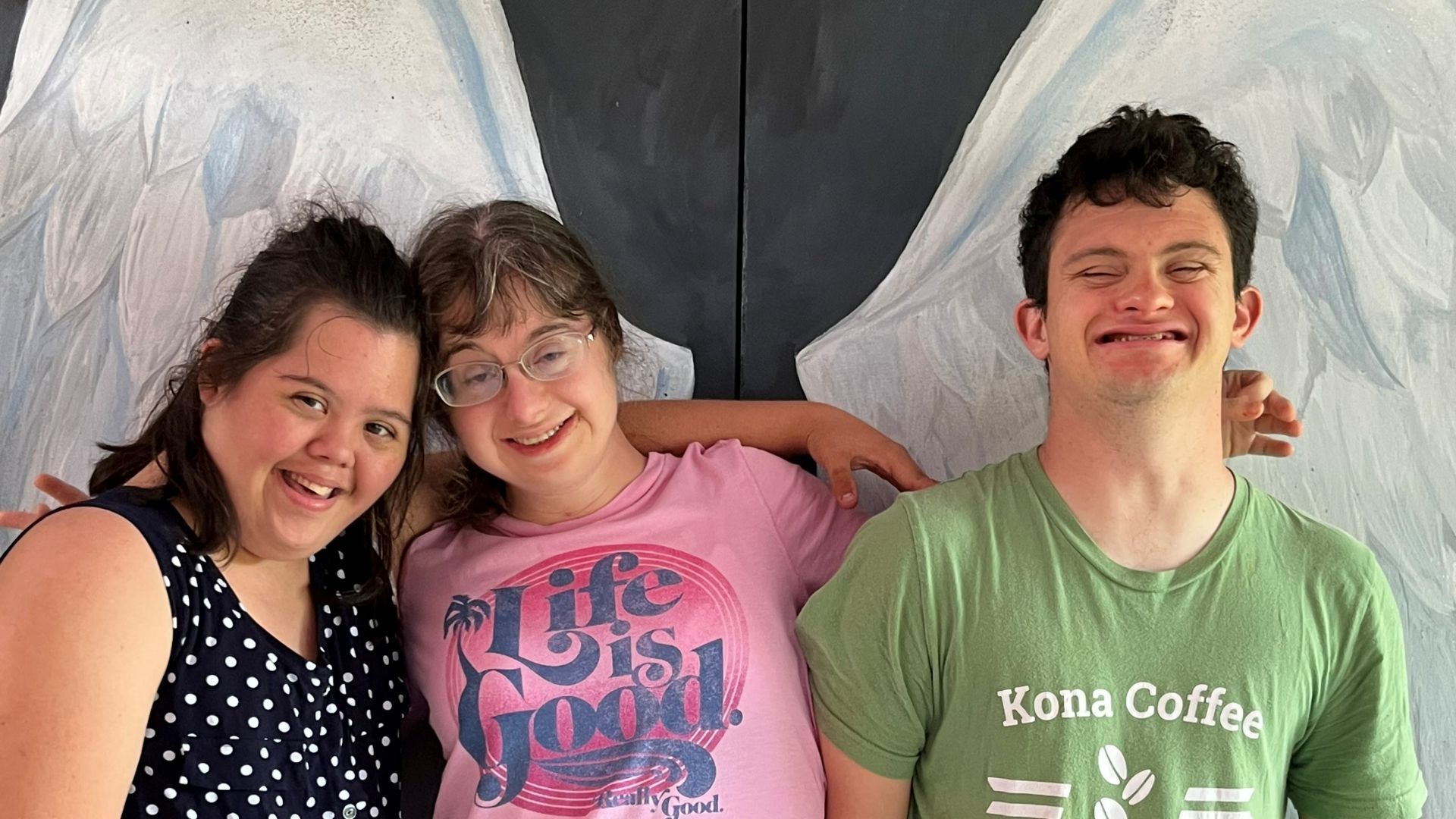 A man and two girls are posing for a picture together.