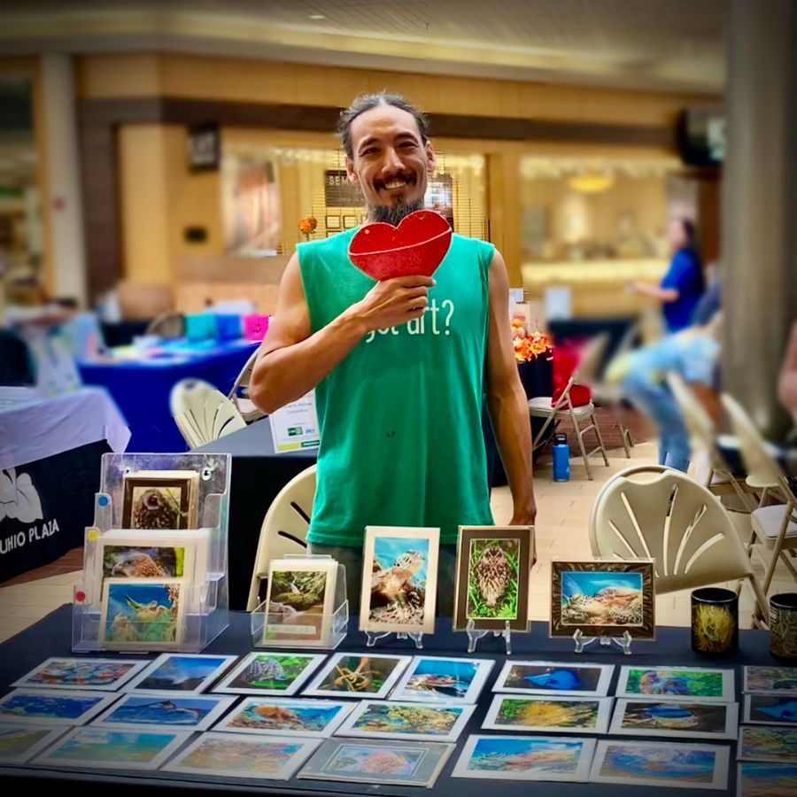 A man in a green tank top with the word art on it