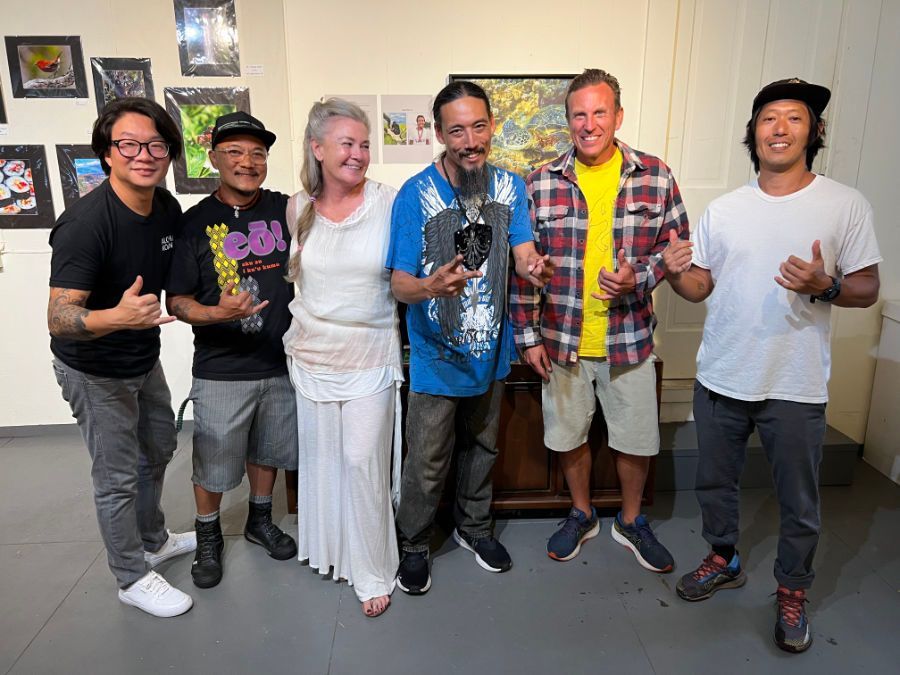 A group of people are posing for a picture in a room.