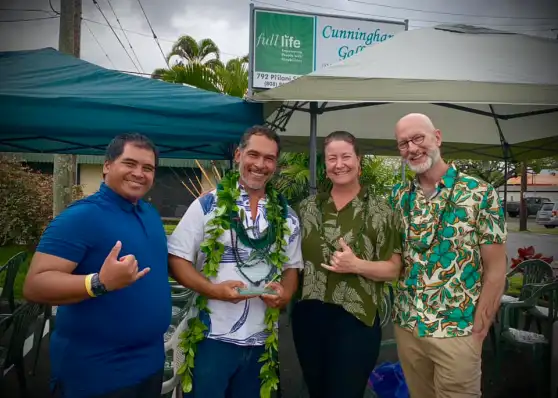 A group of people are posing for a picture in front of a tent.