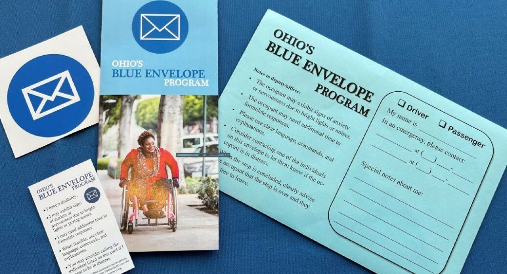 Pictured: a photo of the Blue Envelope Package which  includes a car decal, wallet card, brochure