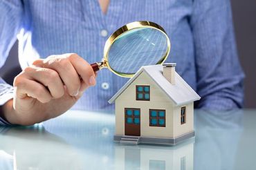 Magnifying glass on small house