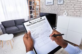 Person filling out real estate appraisal form