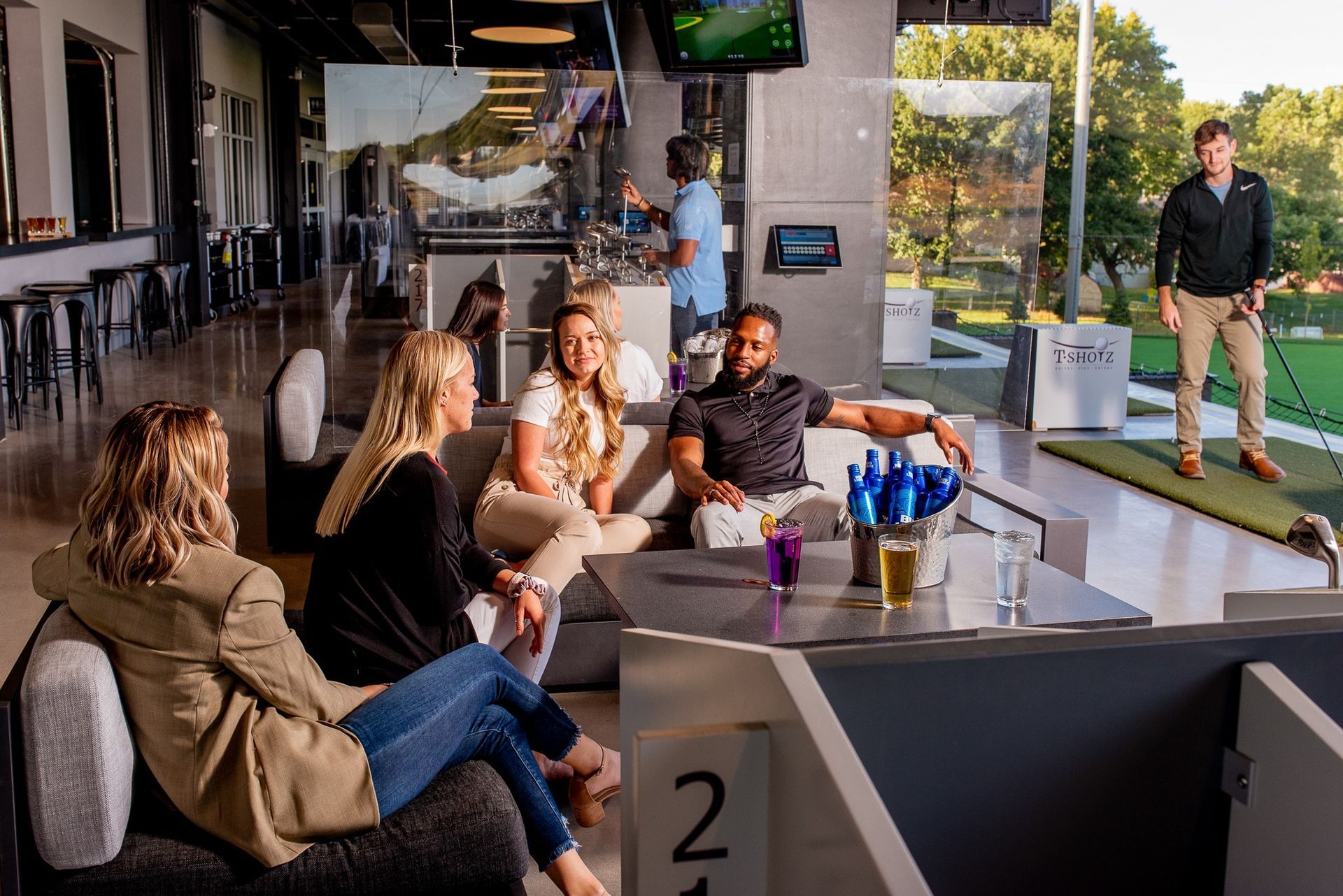A group of people holding paddle rackets on a tennis court