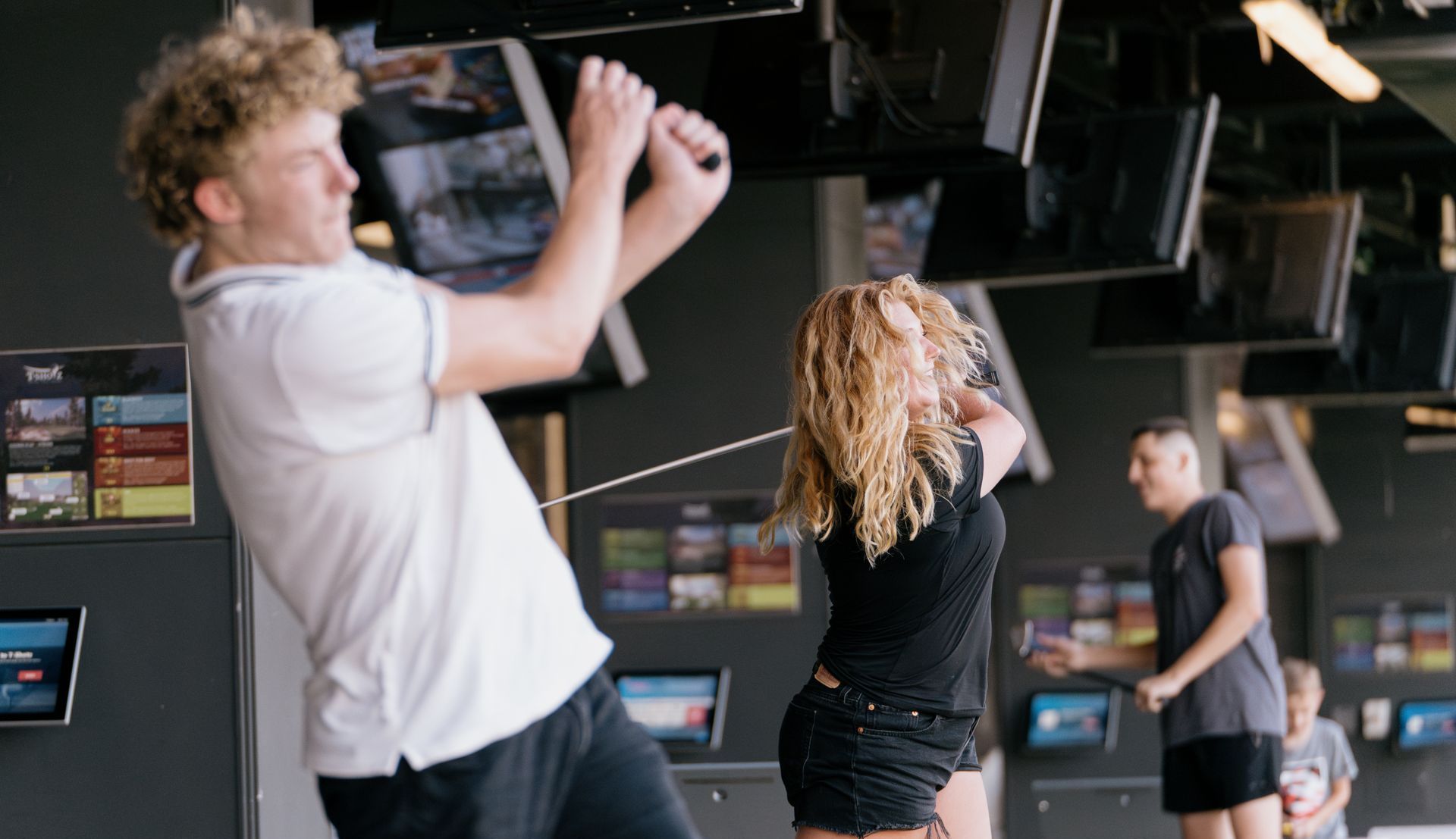 A man and a woman are playing a game in a gym.