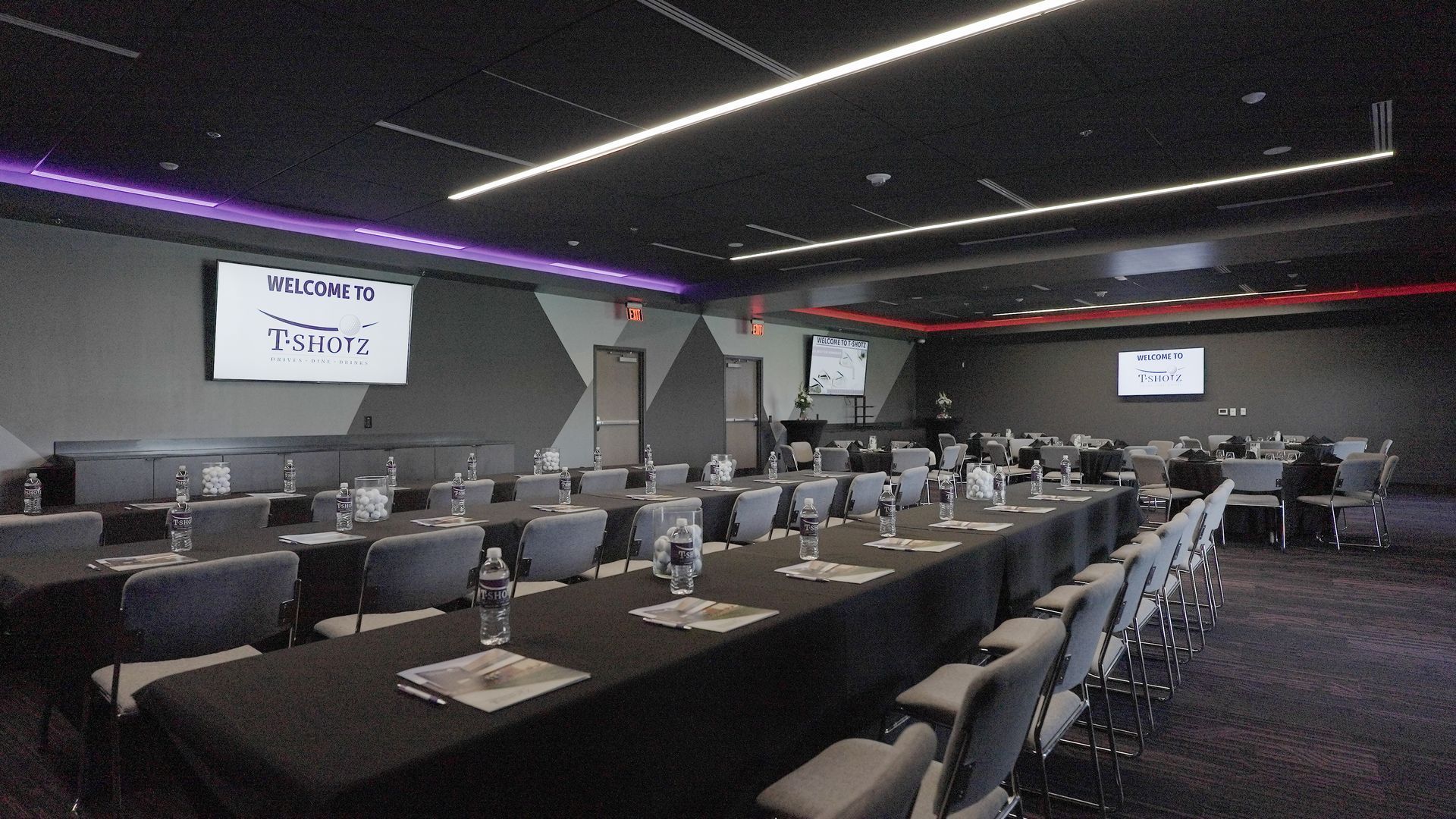 A conference room with tables and chairs set up for a meeting