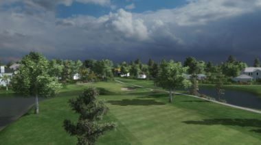 An aerial view of a golf course with trees and houses in the background.