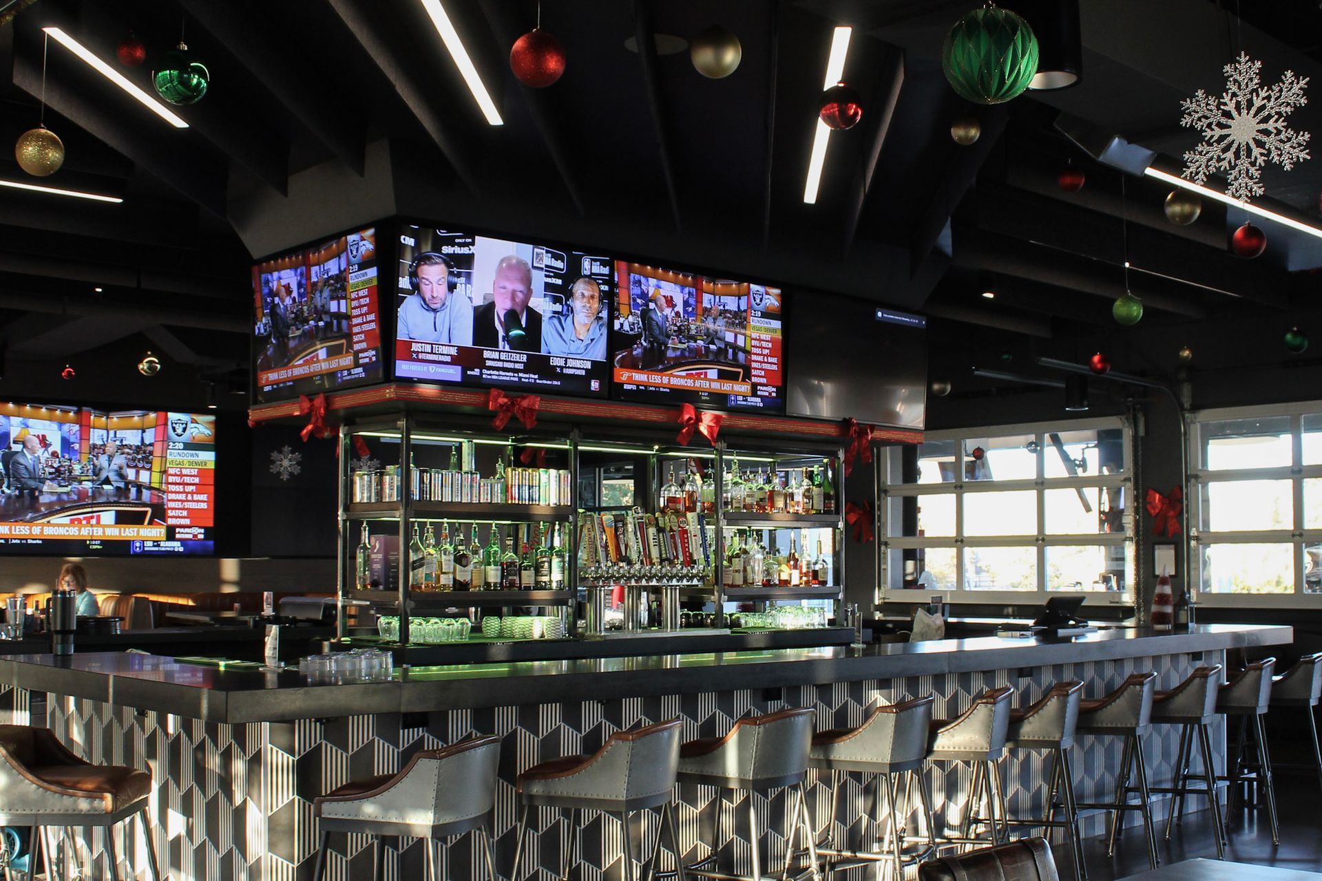 Three young women are posing for a picture together at night.