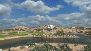 A house sits on top of a hill next to a body of water.