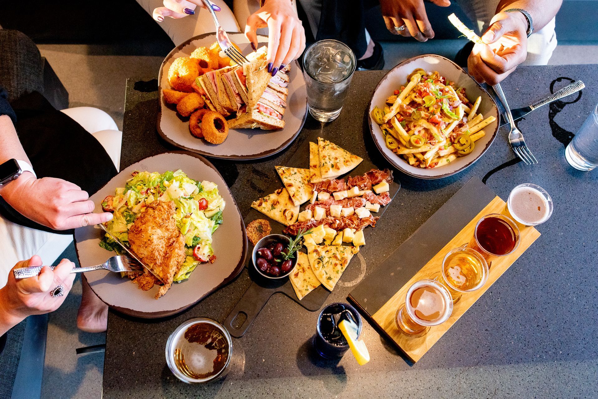 A group of people are sitting at a table eating food.