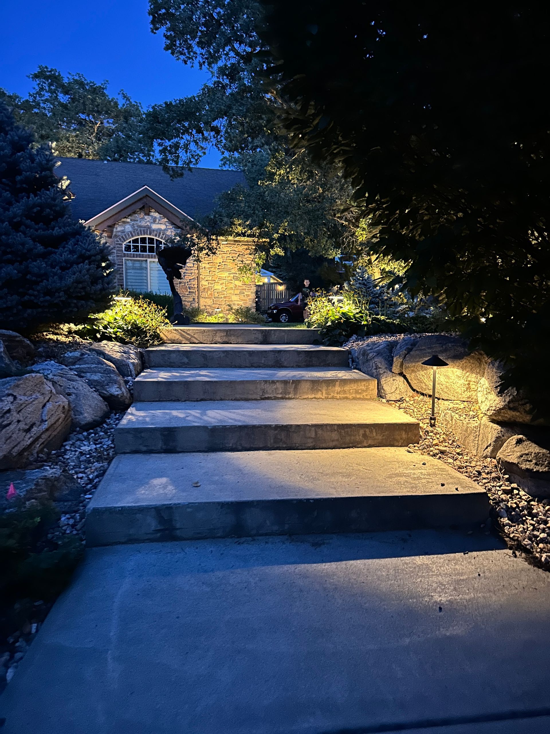 A set of stairs leading up to a house at night