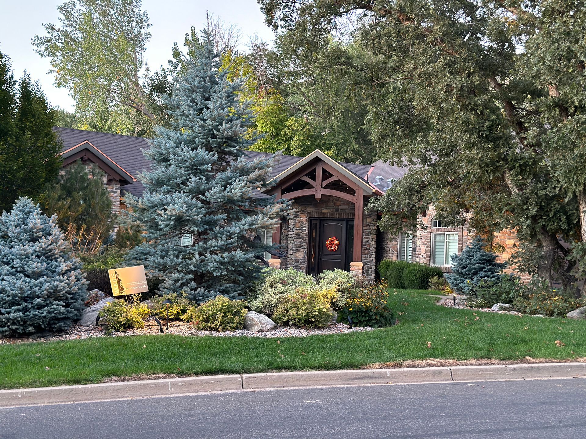 A house with a porch and trees in front of it