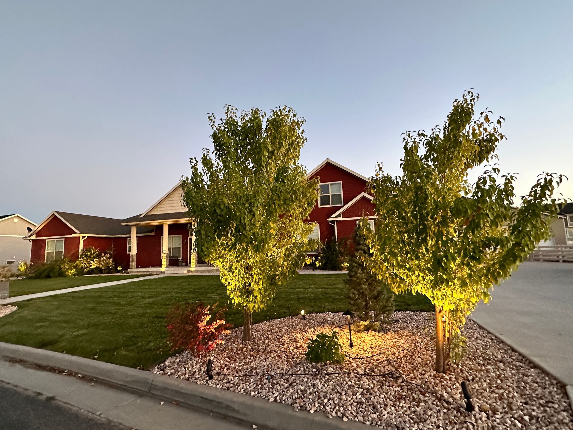 A red house with a lot of trees in front of it