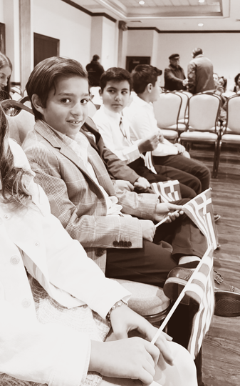 People seated in a conference room, looking toward the camera.