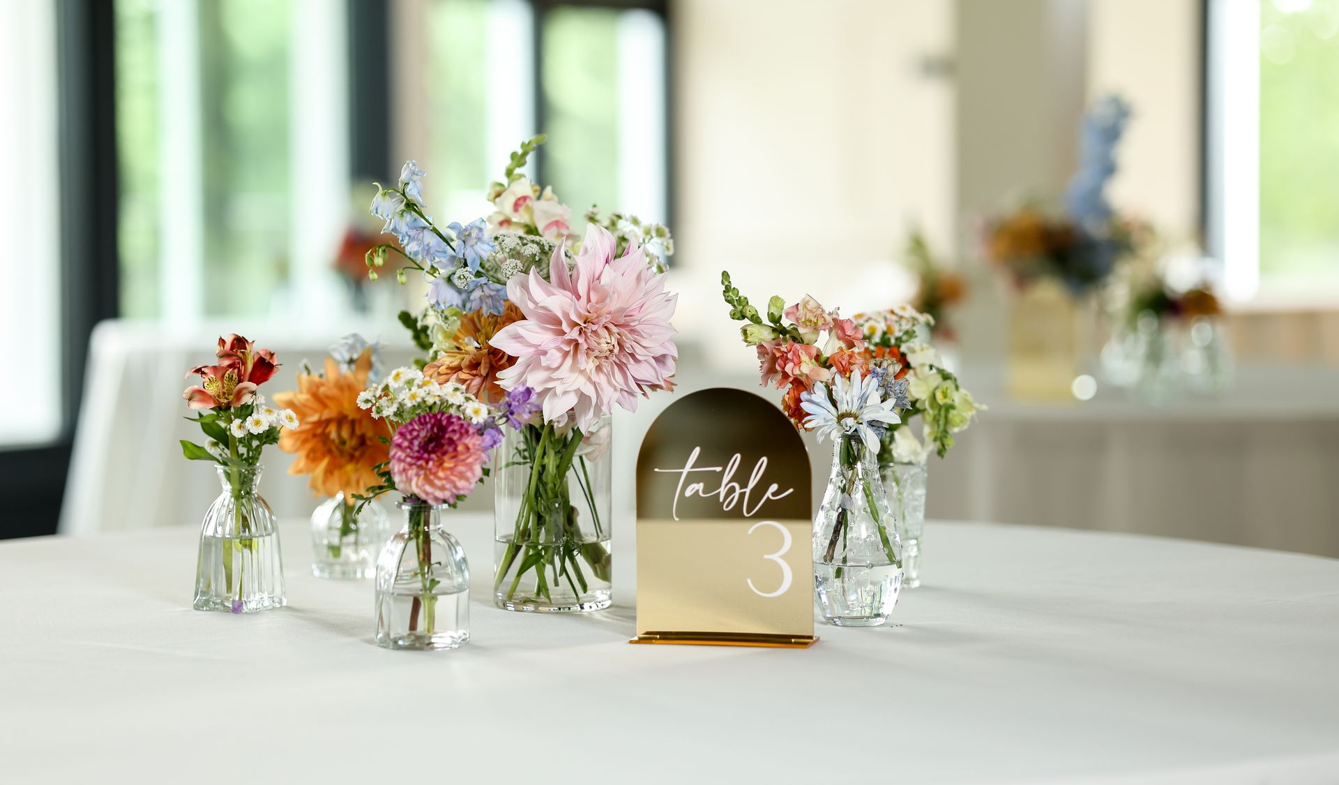 A restaurant with tables and chairs and a lot of windows.