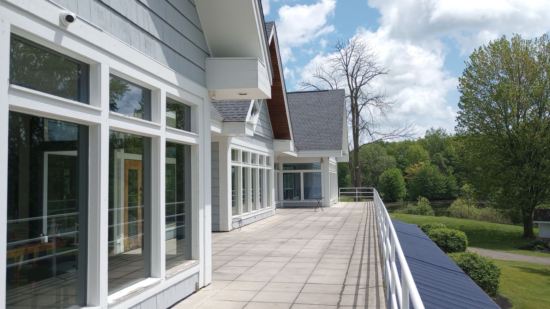 A large white building with a balcony and a lot of windows.