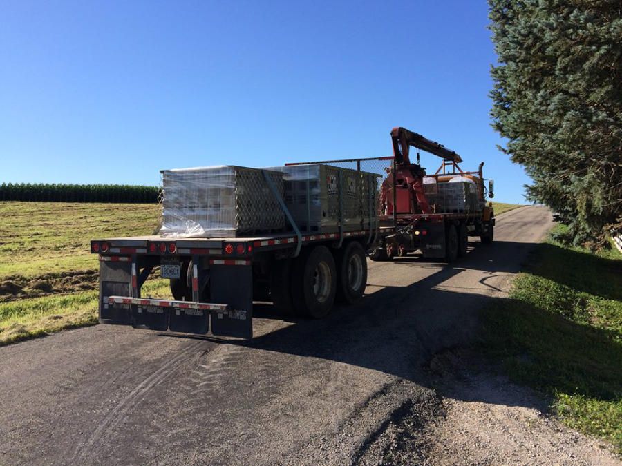 A semi truck is driving down a dirt road | Jack-A-Slab Construction