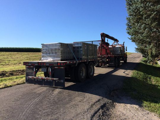 A semi truck is driving down a dirt road | Jack-A-Slab Construction