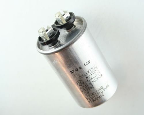 A close up of a capacitor on a white surface