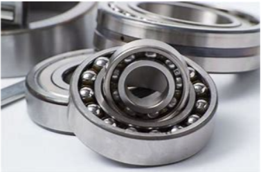 A group of ball bearings are stacked on top of each other on a white surface.