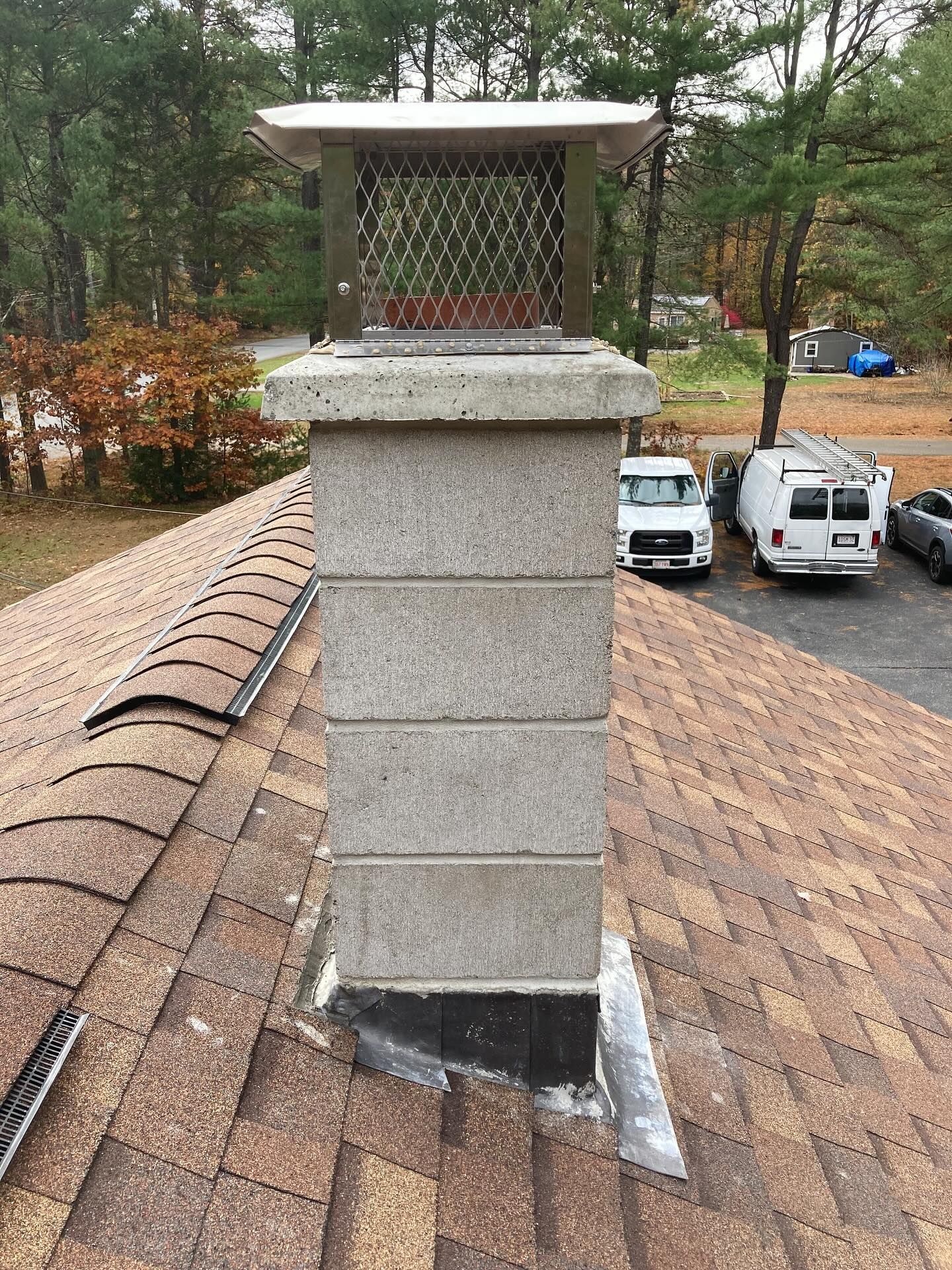 Black and gray melted material in a circular form, with a central hole and textured surface.