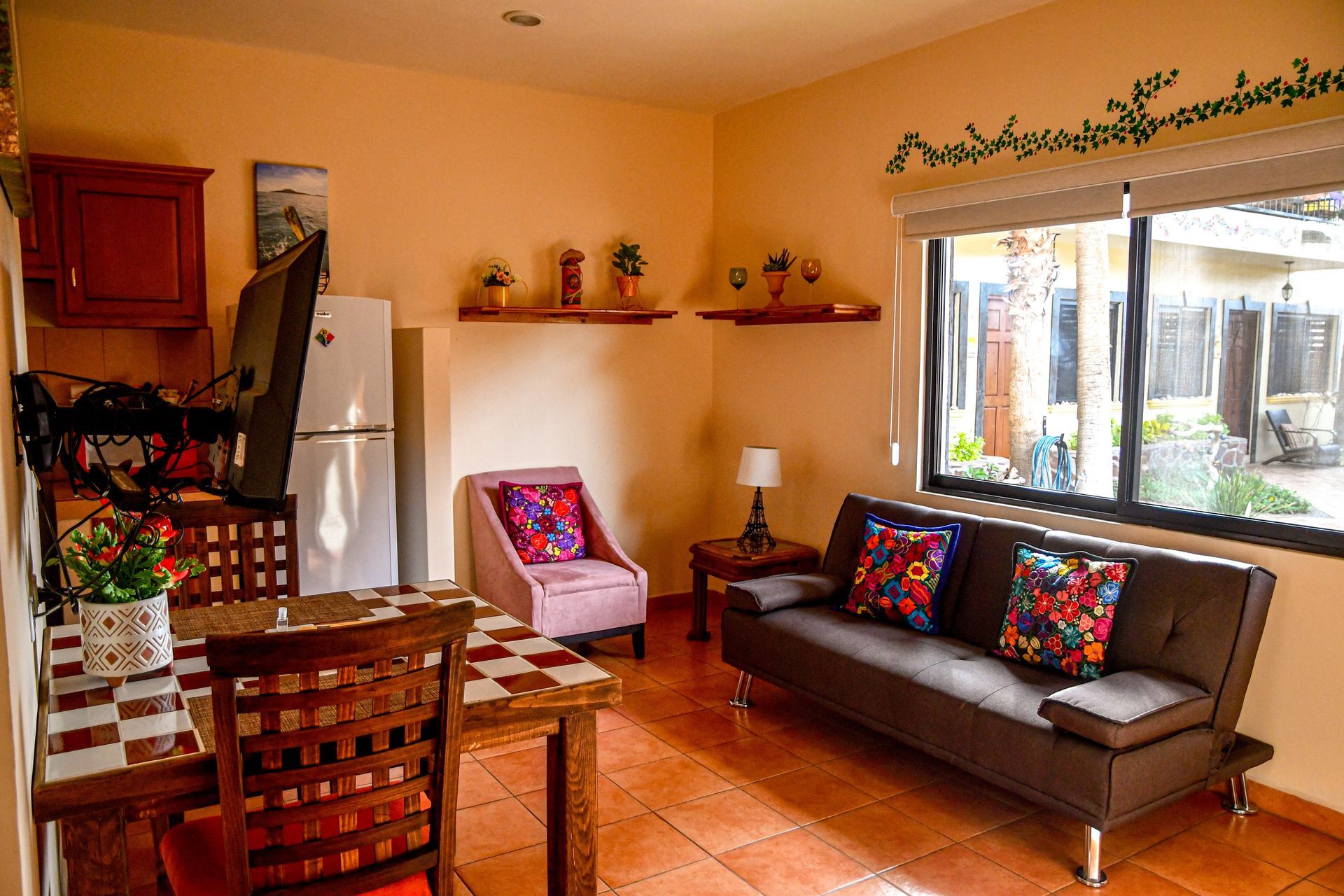 A living room with a couch a table and chairs