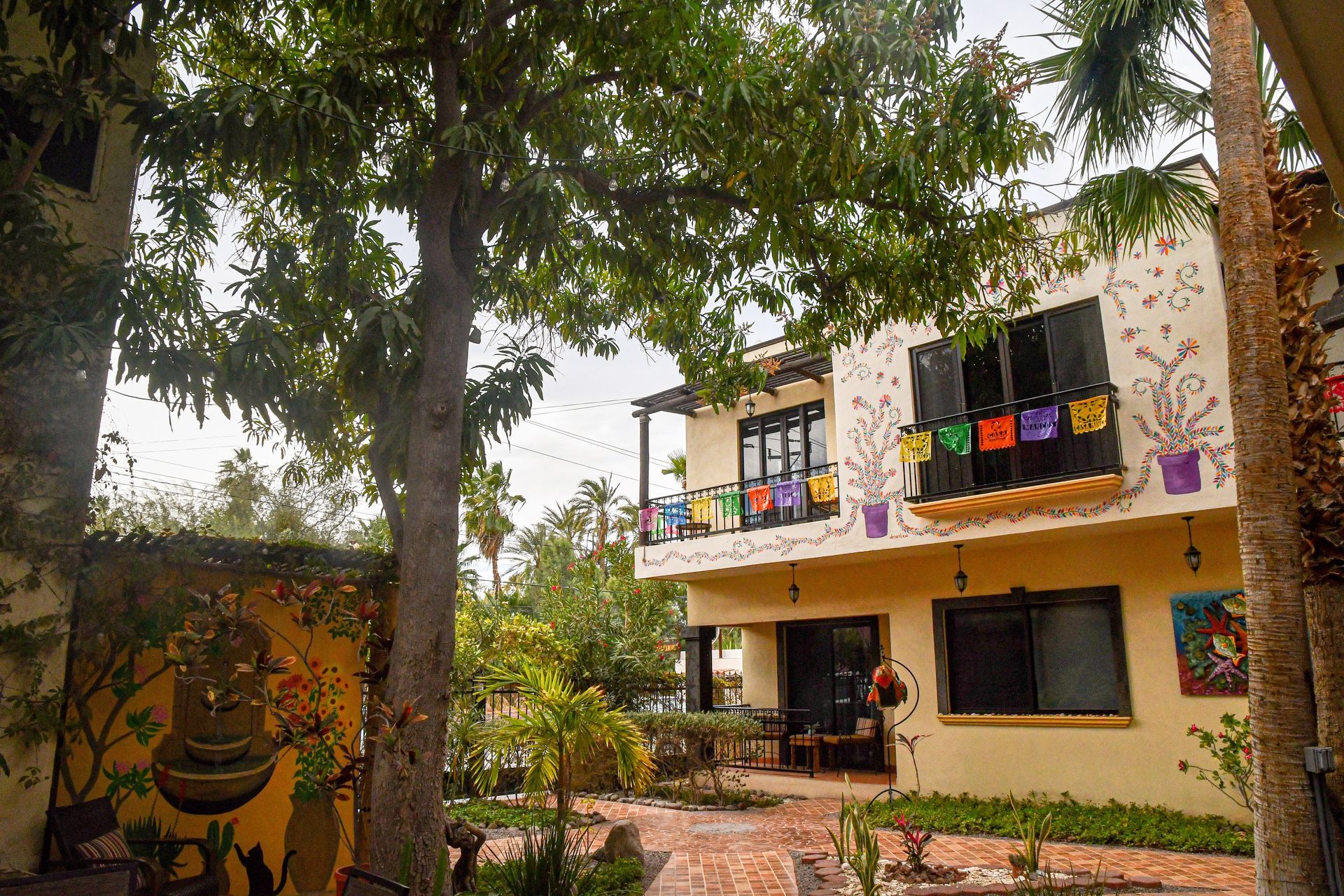 A large house with a lot of windows and trees in front of it.